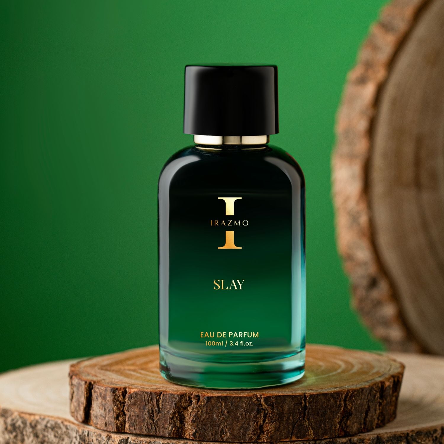 Perfume bottle labeled 'Slay' by Irazmo on a wooden surface with a green background