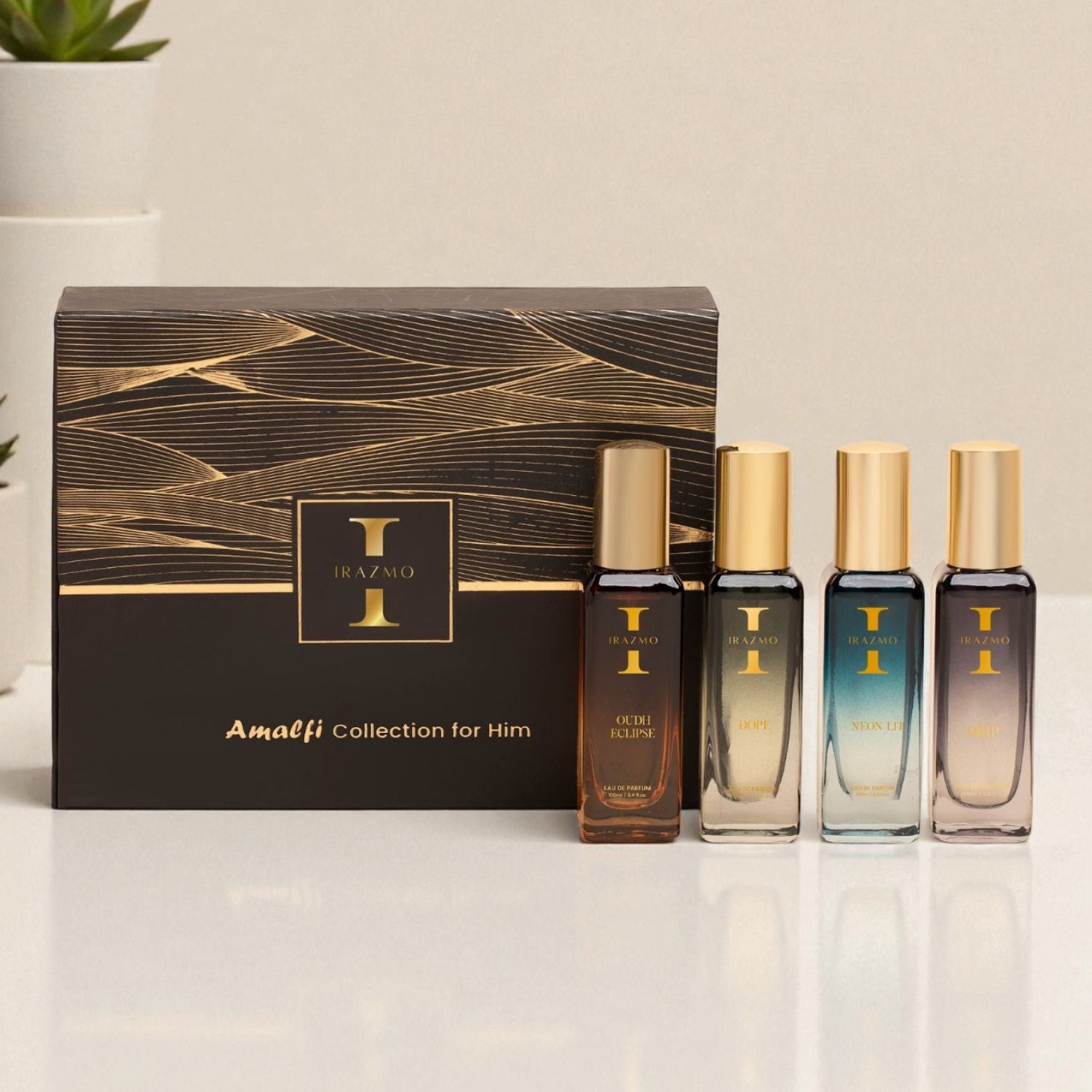 Set of perfume bottles with a decorative box labeled 'Amalfi Collection for Him' on a light surface.