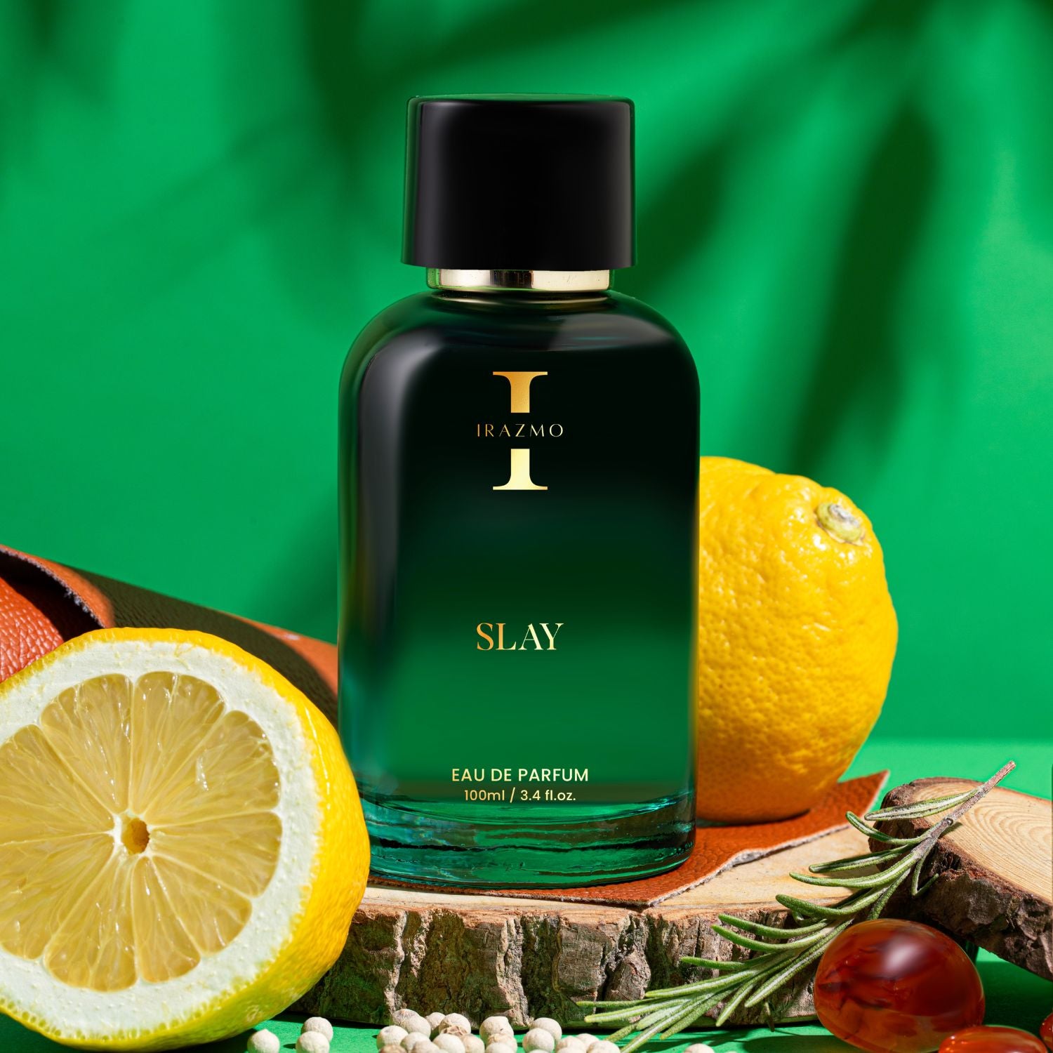 Green perfume bottle labeled 'SLAY' with lemons and other fruits on a green background