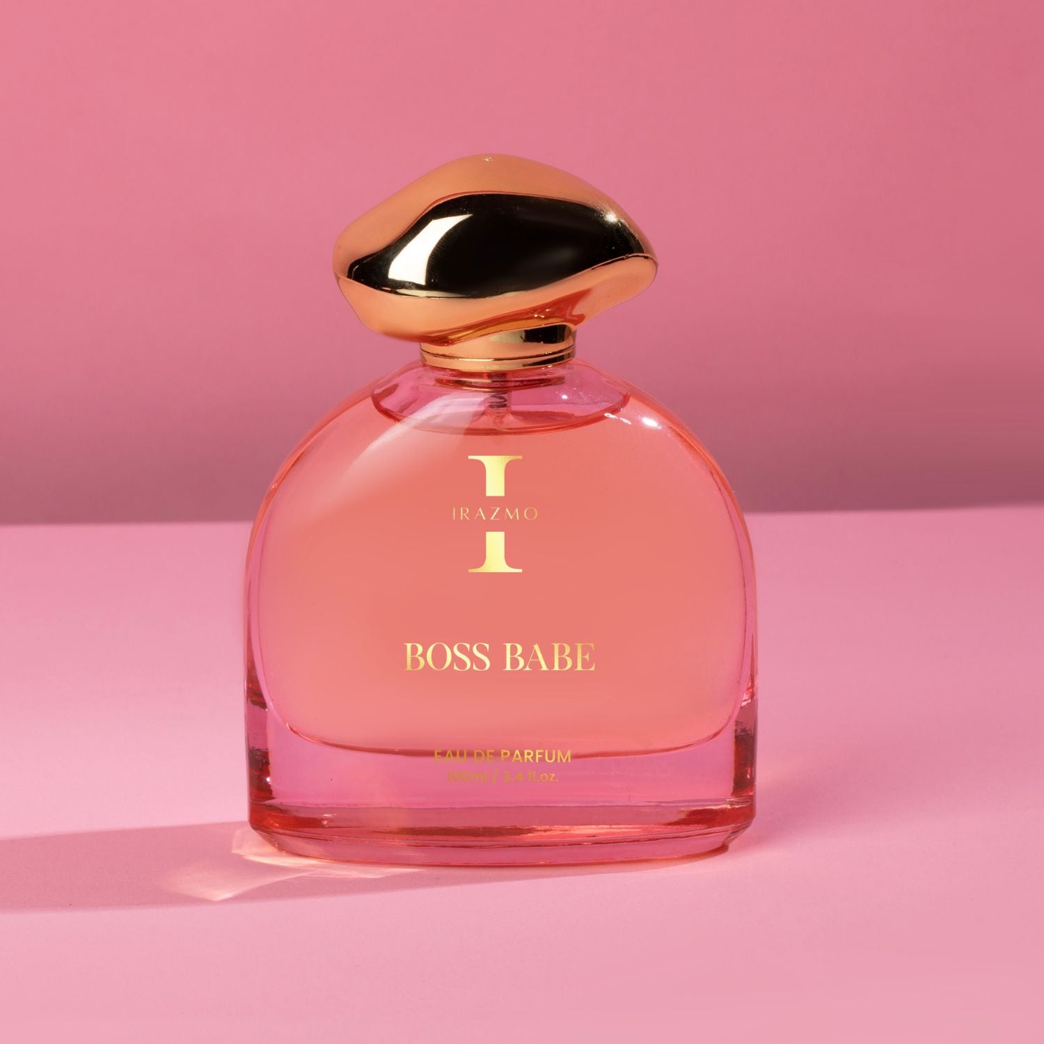 Pink perfume bottle labeled 'BOSS BABE' on a pink background