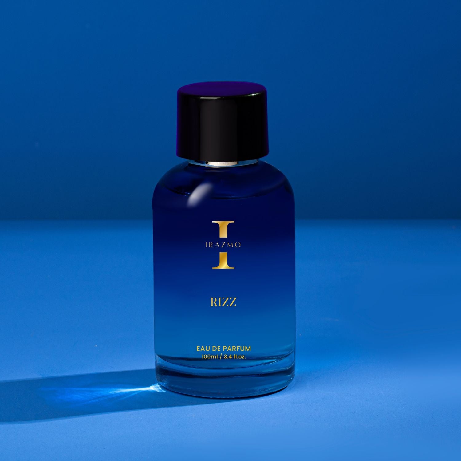 Blue perfume bottle with black cap on a blue background
