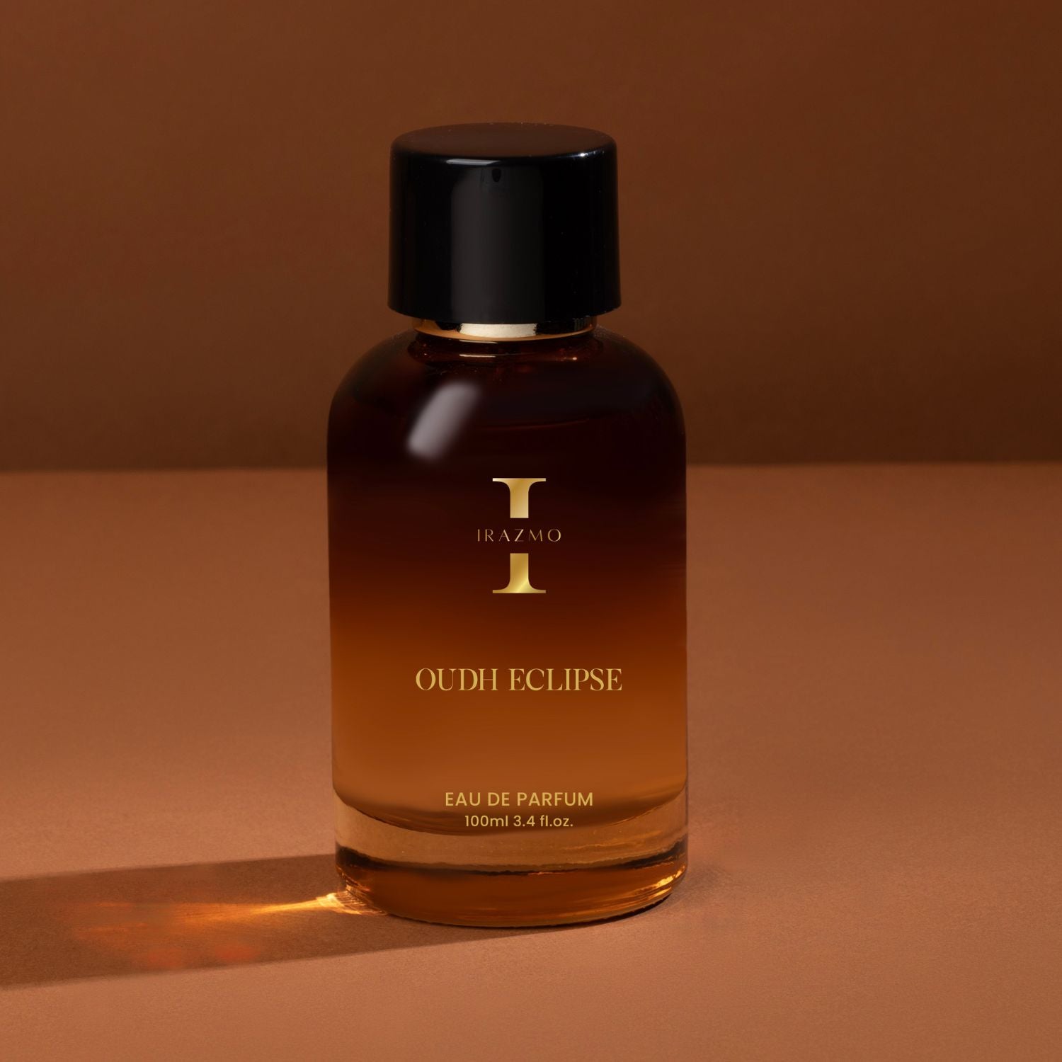 Bottle of Oudh Eclipse perfume on a brown background