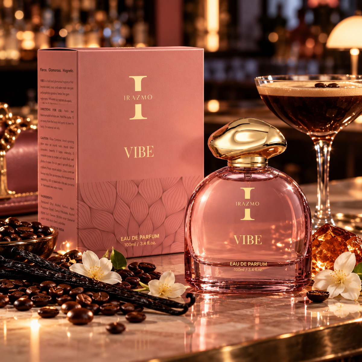 Irazmo Vibe perfume bottle and pink box beside coffee beans, vanilla pods and an espresso martini