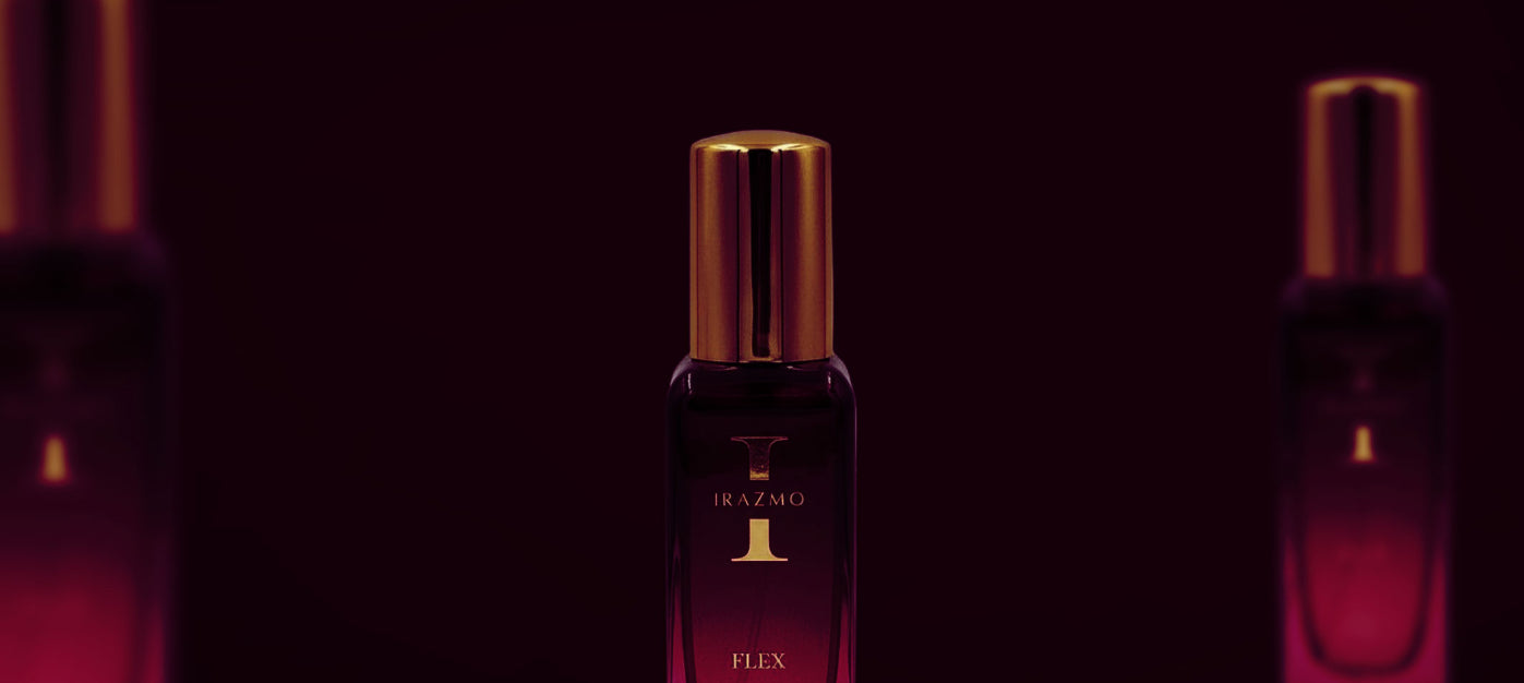 Perfume bottle with gold cap and dark red body on a dark background