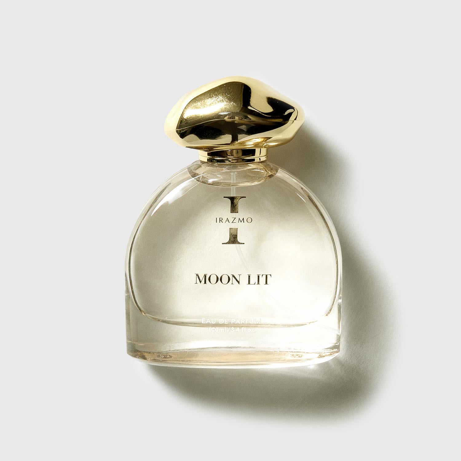 Perfume bottle labeled 'Moon Lit' by Irazmo on a light gray background