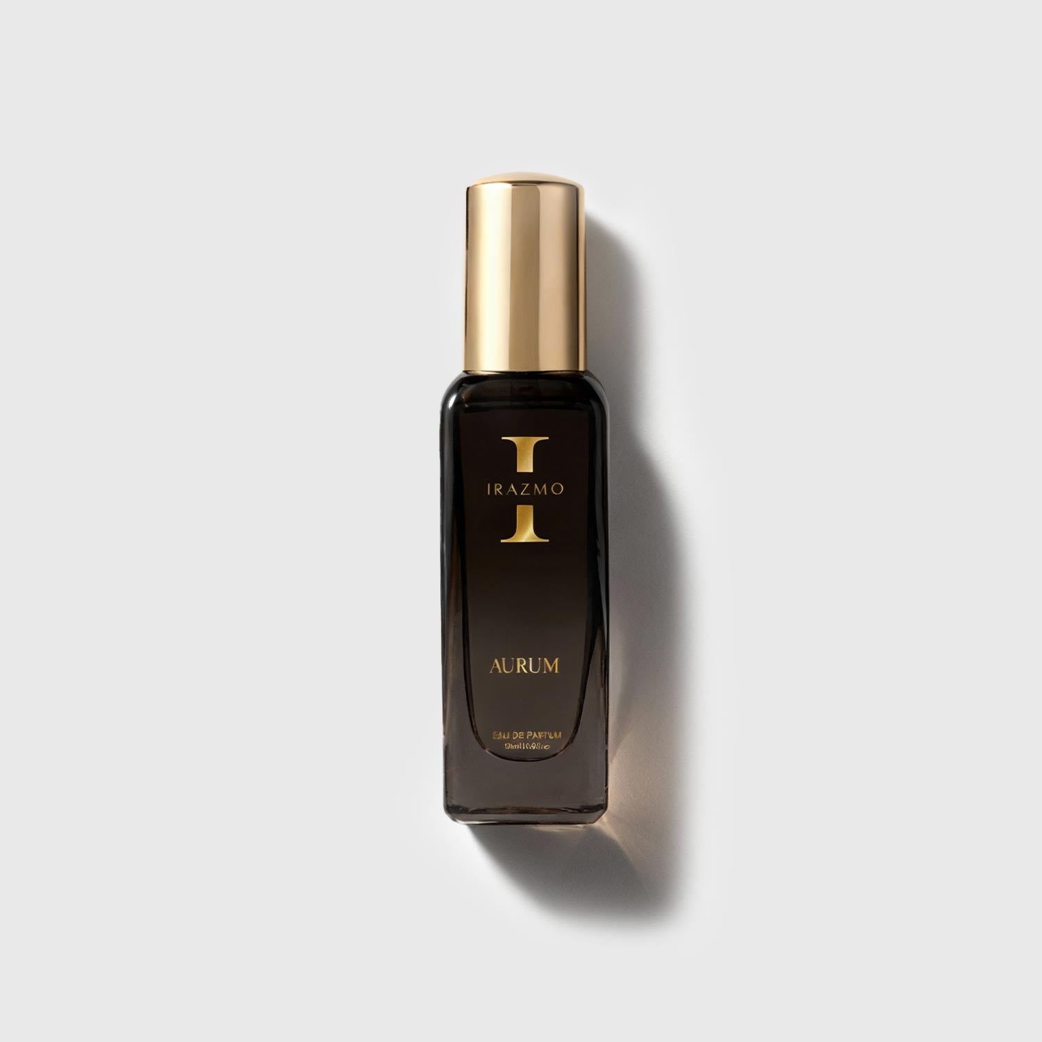 Perfume bottle with gold cap and 'Irazmo' branding on a light gray background