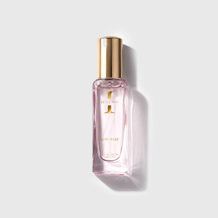 Perfume bottle with gold cap on a light gray background
