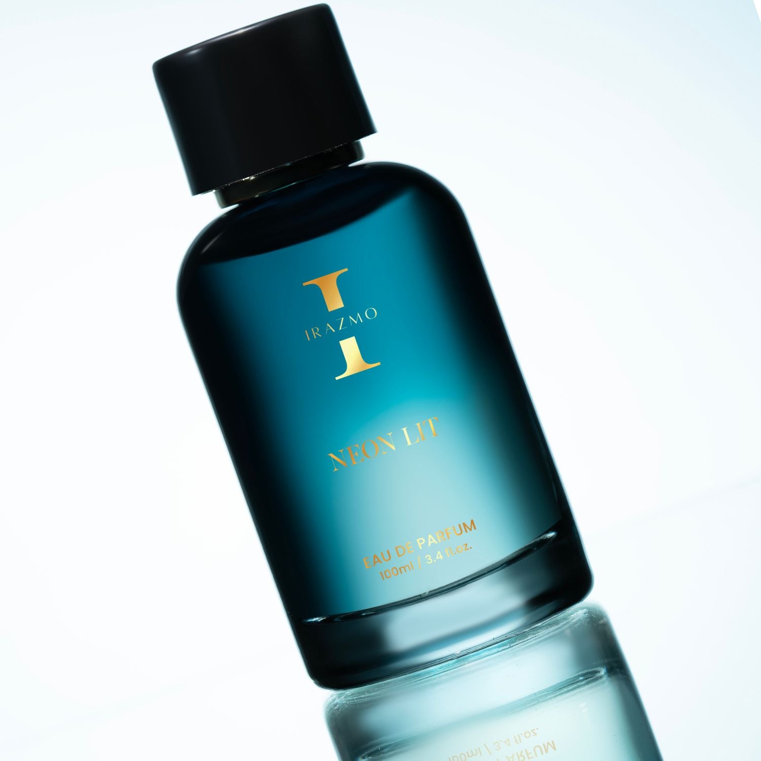 Perfume bottle with black cap and blue body on a light gray background