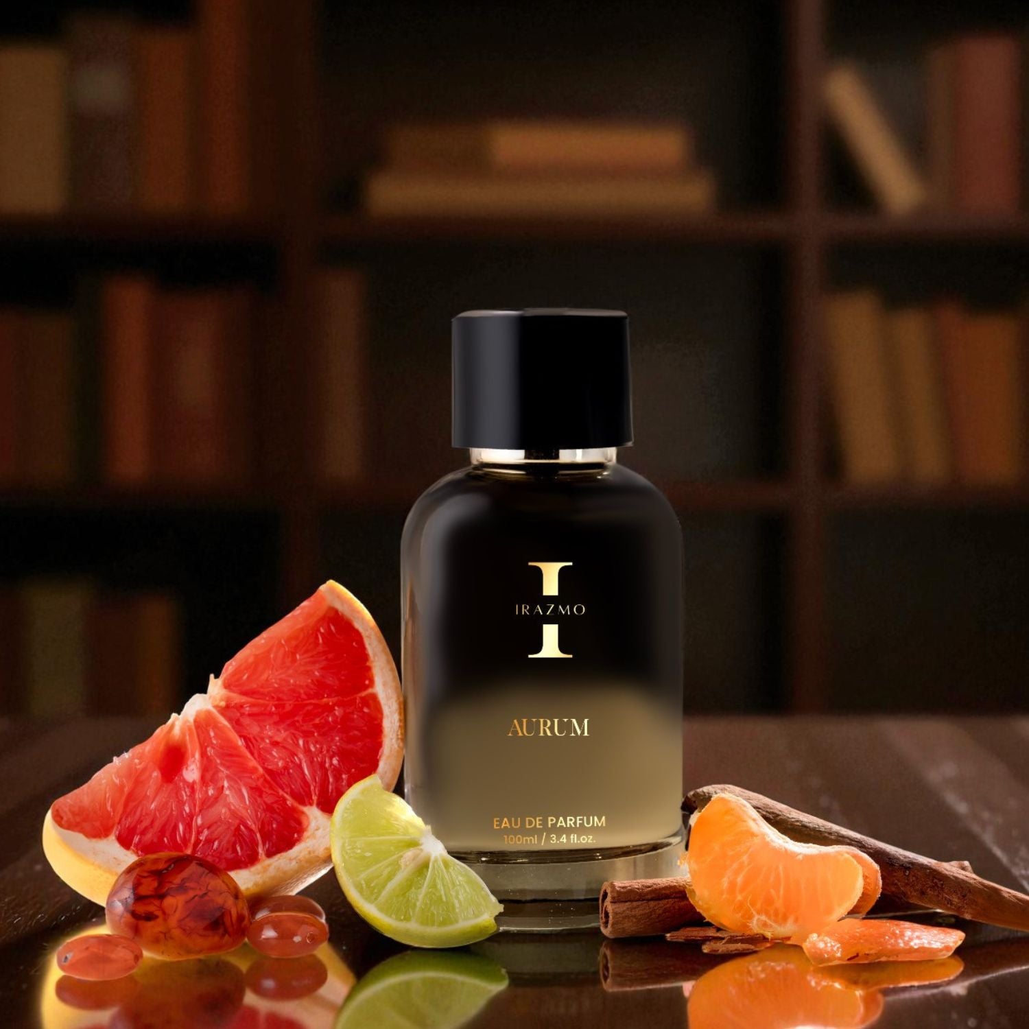 Black perfume bottle labeled 'Aurum' with fruit slices on a reflective surface, bookshelf in the background