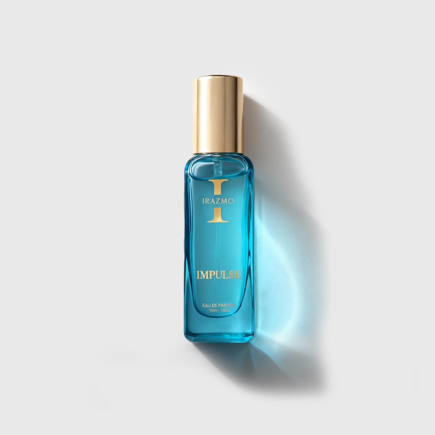 Blue perfume bottle with gold cap on a light gray background