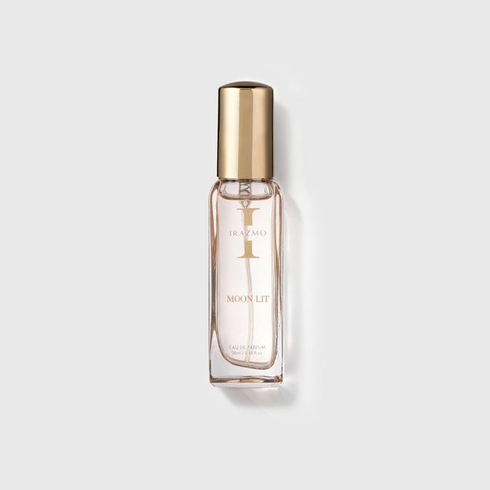 Perfume bottle labeled 'MOON LIT' with gold cap on a light gray background