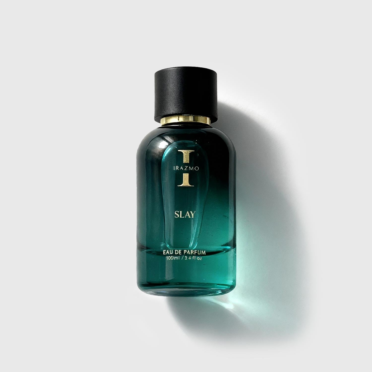 Green perfume bottle with black cap on a light gray background